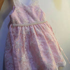 Adorn your baby girl in this elegant Pearl and Lace Work Frock, perfect for making precious memories!






