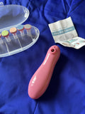 Pink baby nail trimmer with a clear container and instructions on a blue background