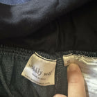 Close-up of a label on dark fabric with 'wobbly walk' branding.