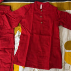 Red pants on a patterned bedspread
