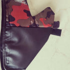 Black leather wallet with camouflage pattern on a light-colored surface
