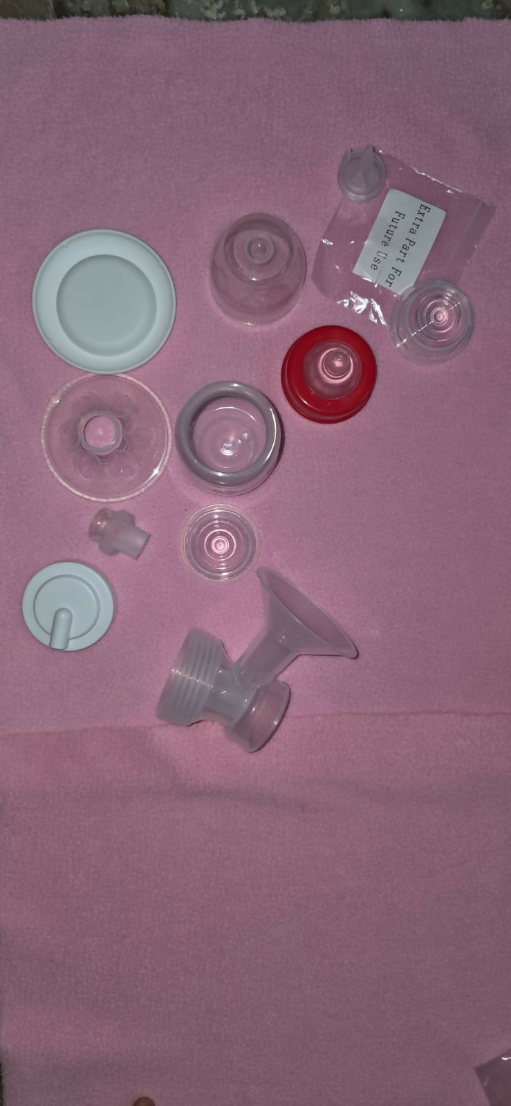 Collection of various plastic bottle caps on a pink surface