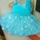 Turquoise children's dress with floral details
