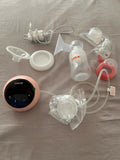 LuvLap Adore electric breast pump with adjustable suction, compact design, milk collection bottle, and comfortable pumping support for breastfeeding mothers.