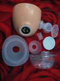 Baby bottle nipple and connector set on a red fabric background