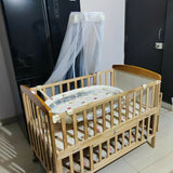 Ensure your baby's comfort and safety with the BABYHUG Kelly Wooden Crib/Cot – featuring a detachable bassinet, mosquito net, and smooth-rolling casters for easy mobility and convenience.