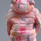 Child wearing a colorful pink puffer jacket with letter patterns 
