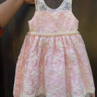 Adorn your baby girl in this elegant Pearl and Lace Work Frock, perfect for making precious memories!






