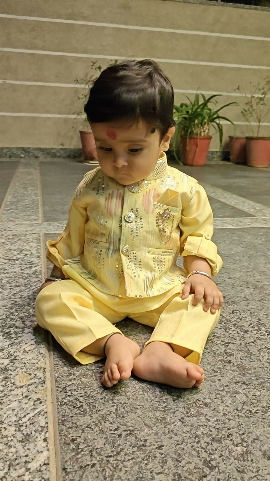 Child in a yellow traditional outfit 