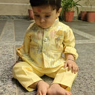 Child in a yellow traditional outfit 