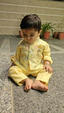 Child in a yellow traditional outfit 