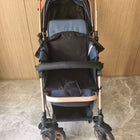 Black and rose gold stroller on a stone floor 