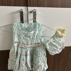 Light green children's dress with floral pattern 