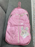 Pink checkered backpack with a cartoon bunny design on a gray surface