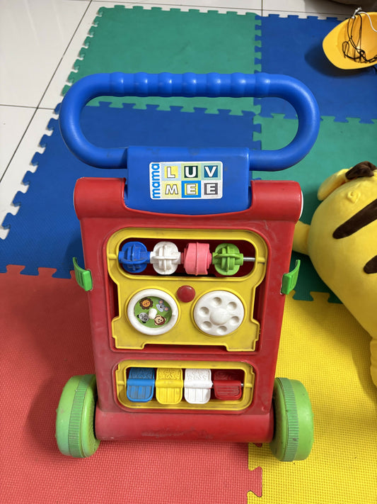Colorful toy push cart with multiple interactive elements 