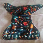 Space-themed diaper cover with planets and stars on a plain background