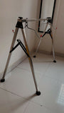 Metal workbench stand on a tiled floor with a white wall background