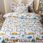 Children's single bed with a road-themed comforter and pillows