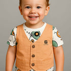 Child wearing a patterned shirt with a vest 