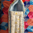 Baby crib with patterned mattress on a colorful quilt