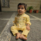 Child in a yellow traditional outfit 