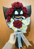 Bouquet with crochet flowers and a small figurine held by a hand against a wooden background