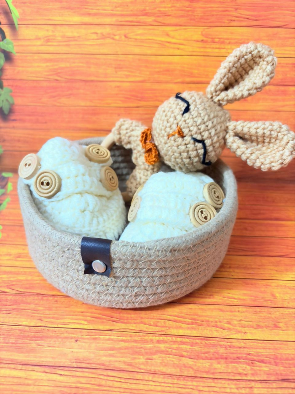 Handmade crochet bunny in a basket on a wooden surface