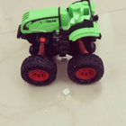Toy car with green body and black wheels on a light-colored floor.