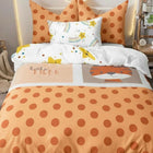 Children's single bed comforter with orange polka dot pattern and cartoon designs 