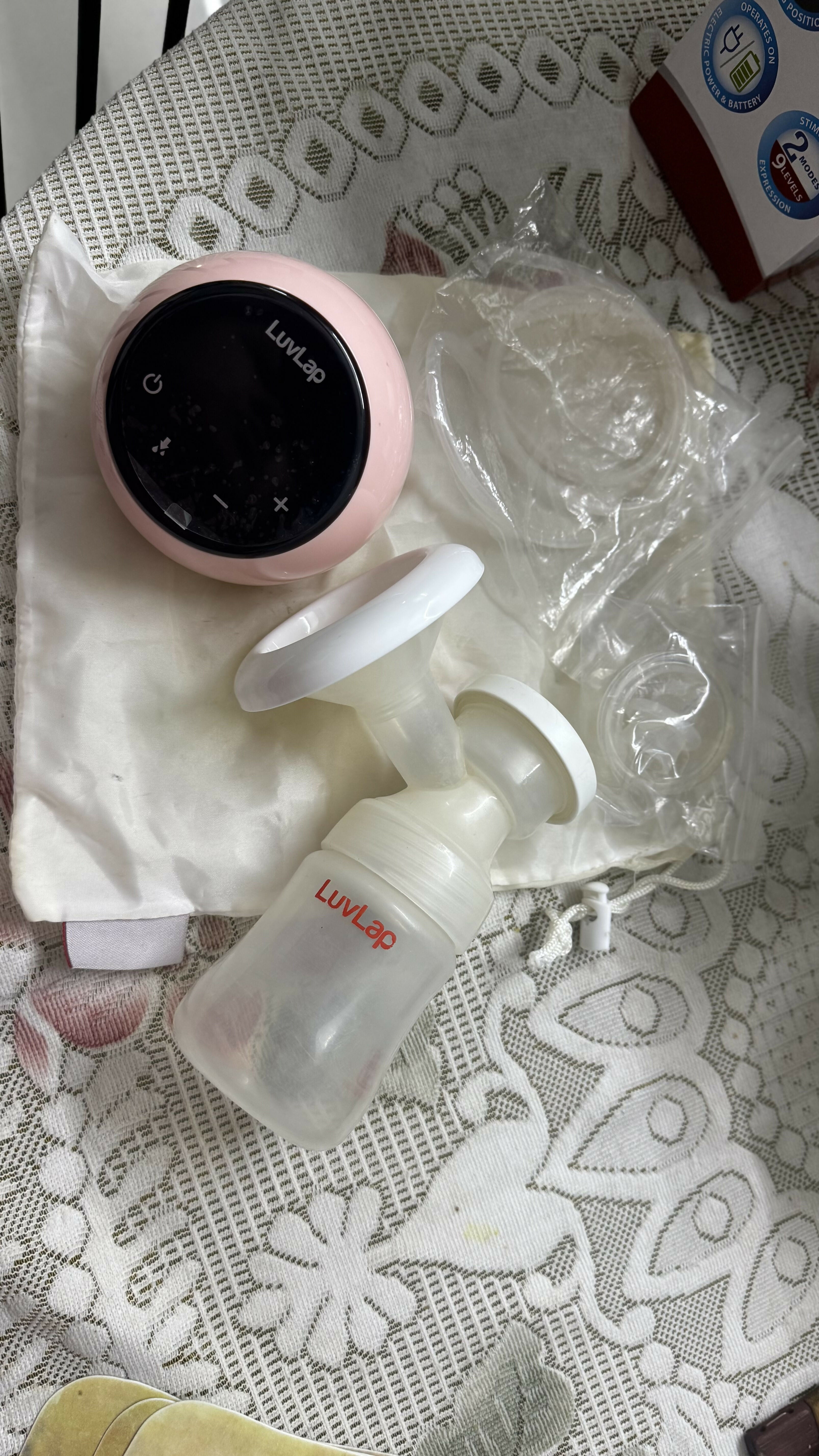 Lupin baby bottle and digital thermometer on a textured surface
