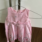 Pink children's dress with floral patterns 