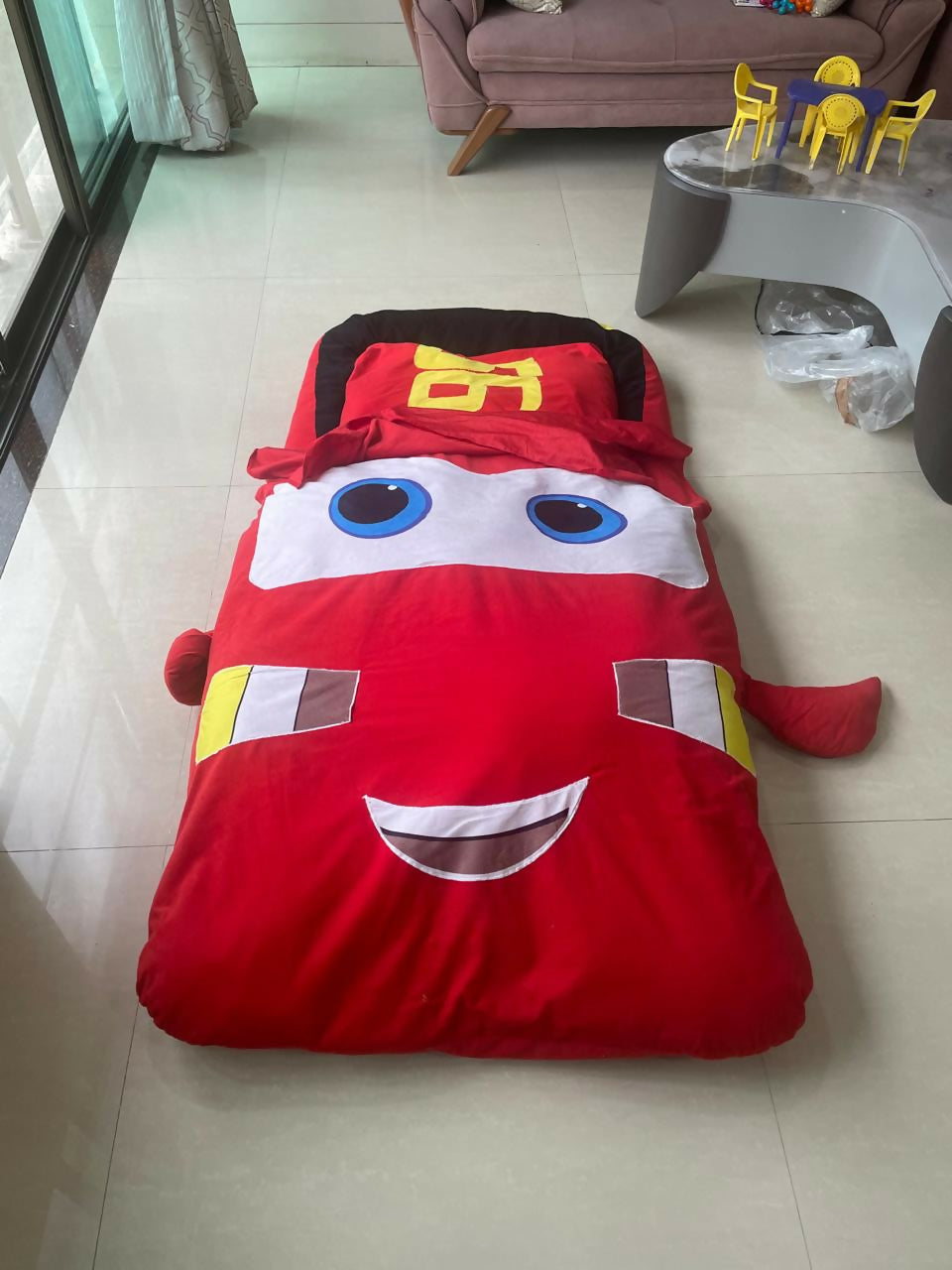 Transform bedtime into a thrilling adventure with the Red Toy Car Bed with Attached Blanket – a vibrant and cozy race car bed that ensures your child stays warm and secure all night.
