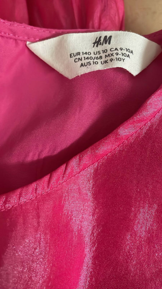 Close-up of an H&M label on a pink garment