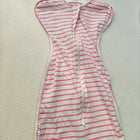Striped dress on a hanger with 'Milan' label on a textured surface
