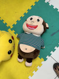 Plush monkey toy with a striped shirt 