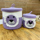 Two purple and white bear-themed storage baskets 