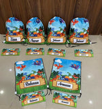 Set of drawstring bags with dinosaur designs and names on a beige surface.