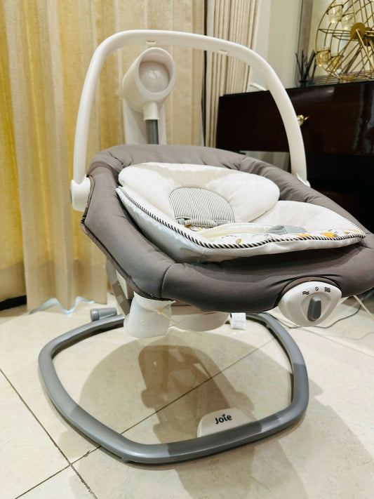 Soothe and entertain your baby with the JOIE Electric Swing, featuring multiple speeds and gentle vibrations for optimal comfort and relaxation.