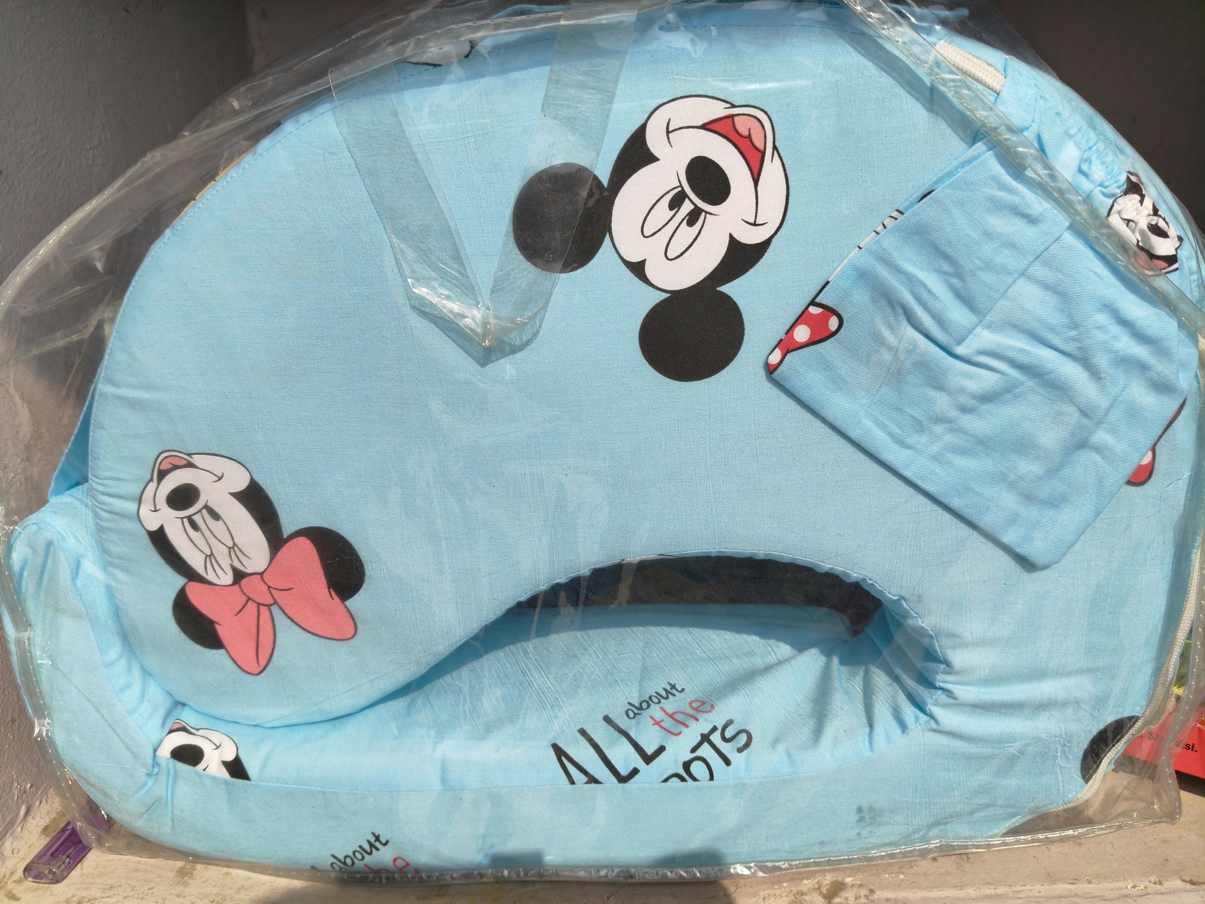 Blue baby seat cover with cartoon character design on a clear background