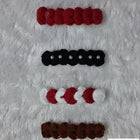 Set of red, black, white, and brown hair ties 