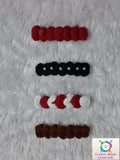 Set of red, black, white, and brown hair ties 