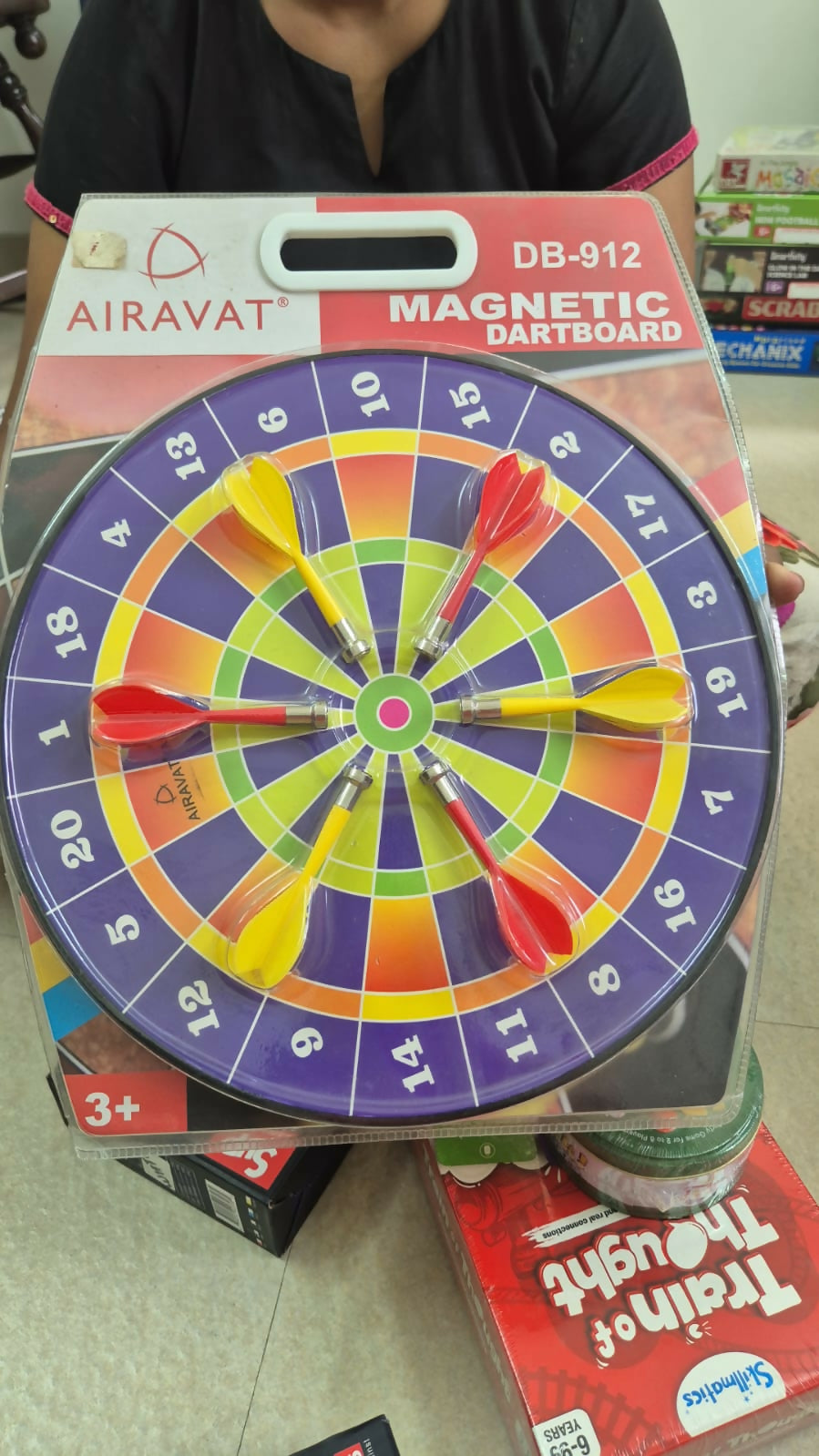 Magnetic dartboard with darts on a colorful target