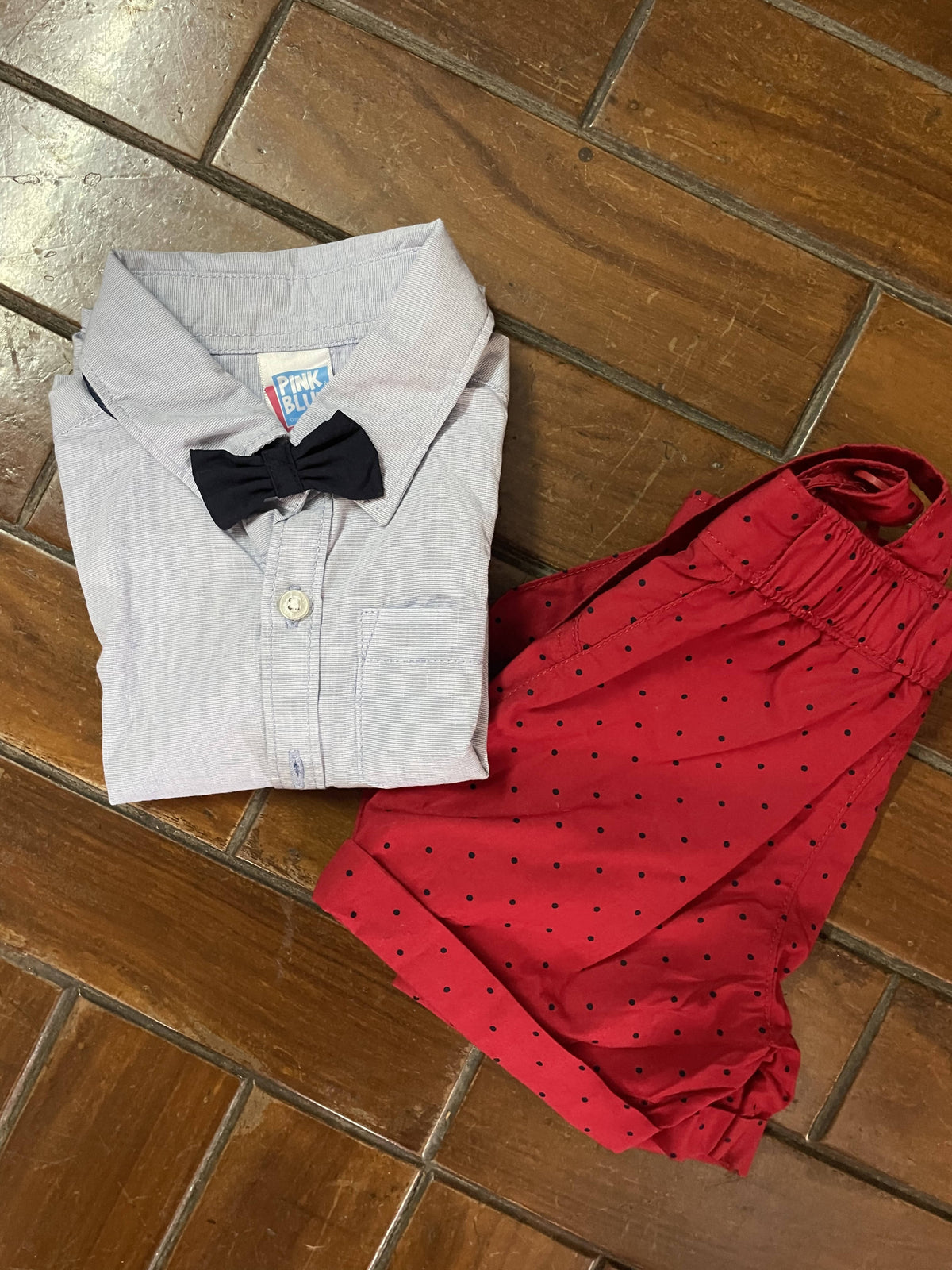 Blue shirt with bow tie and red dungaree