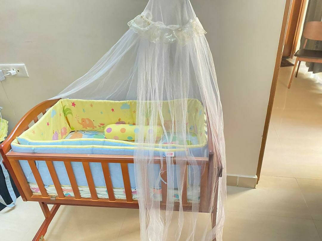 Introducing the BABYHUG Cradle with Mosquito Net and Mattress—a complete sleep solution for your little one's comfort and safety.